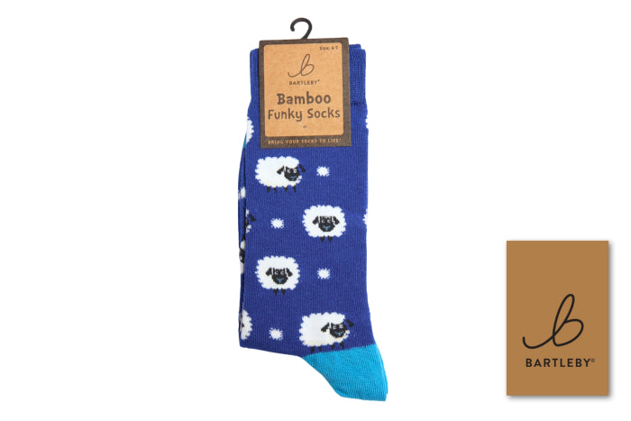 Blue socks with white sheep pattern and Bartley brand packaging on a white background
